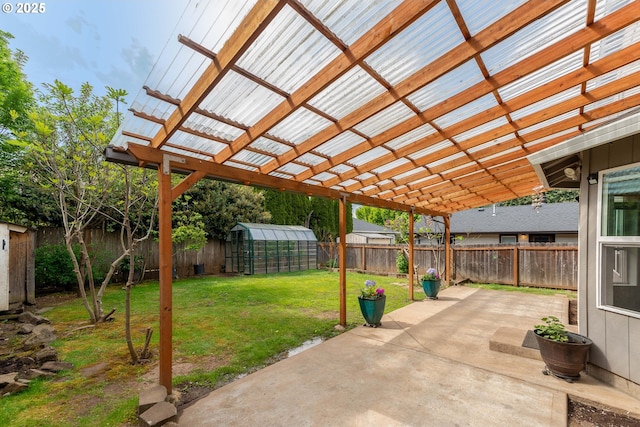 view of patio with a fenced backyard, an outbuilding, an exterior structure, and a pergola