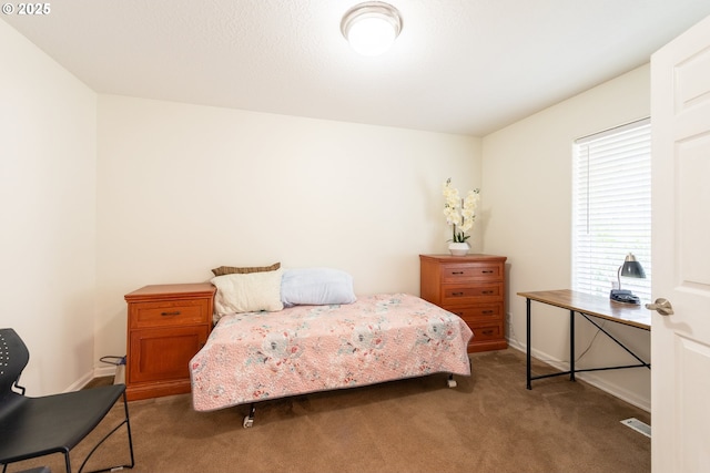 bedroom with baseboards and carpet