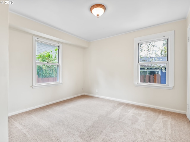 carpeted empty room with baseboards