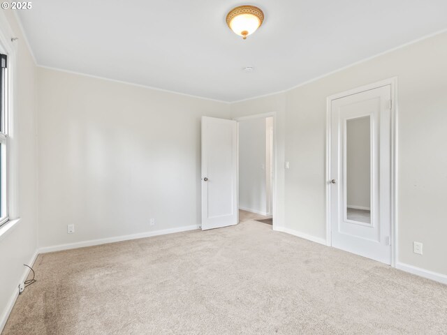 carpeted empty room with baseboards