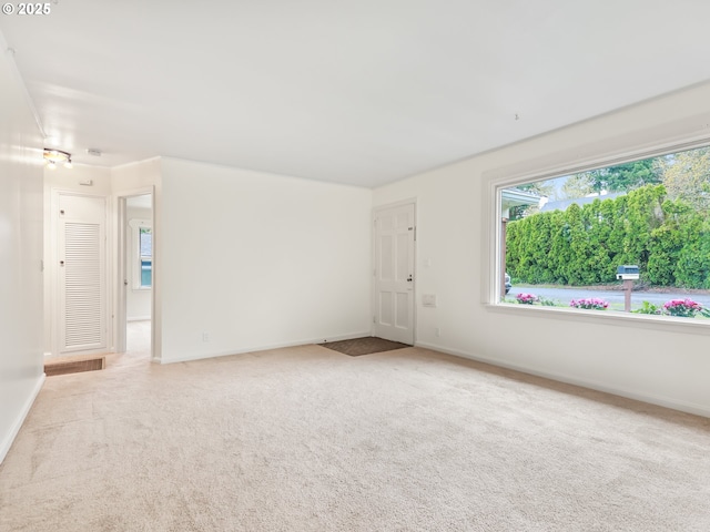 carpeted spare room with baseboards