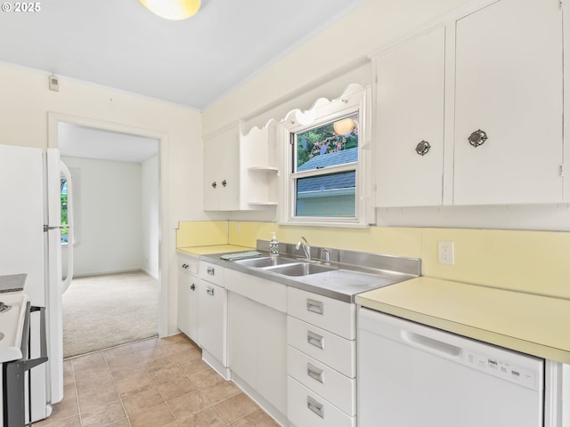 kitchen featuring light countertops, white cabinetry, a sink, and white appliances