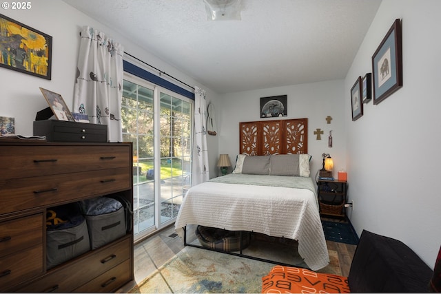 bedroom featuring access to exterior and a textured ceiling