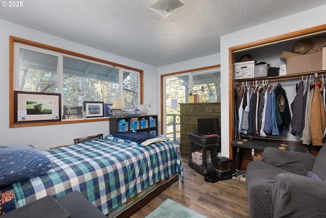 bedroom with hardwood / wood-style flooring, a closet, and a textured ceiling