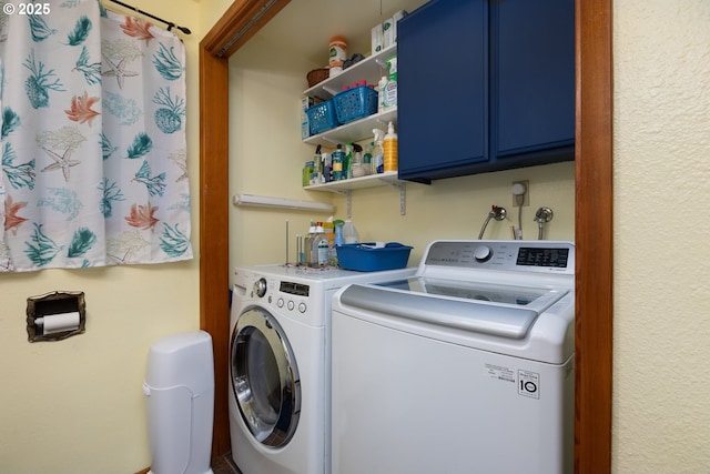 clothes washing area featuring cabinets and washer and dryer