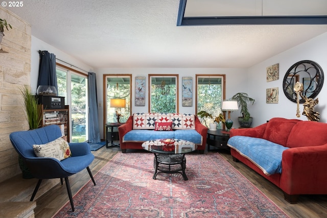 living room with hardwood / wood-style flooring and a textured ceiling