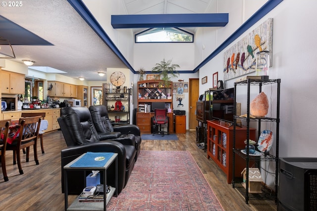 living room featuring plenty of natural light, dark hardwood / wood-style flooring, and a high ceiling