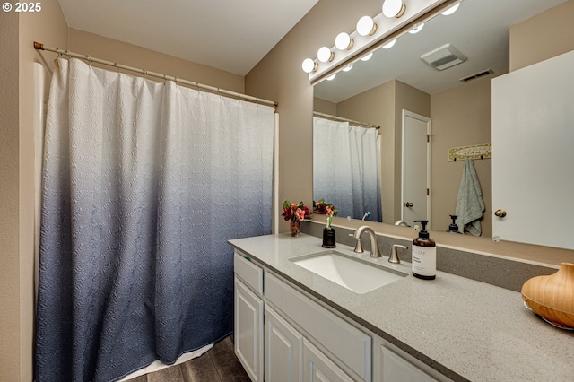 full bathroom with wood finished floors and vanity