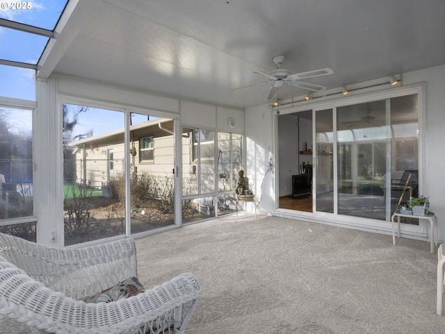 unfurnished sunroom with ceiling fan and a healthy amount of sunlight