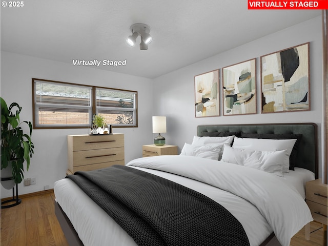 bedroom with wood-type flooring