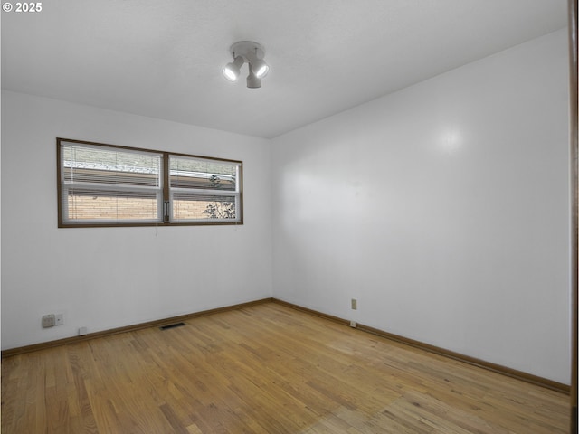 empty room with light hardwood / wood-style flooring