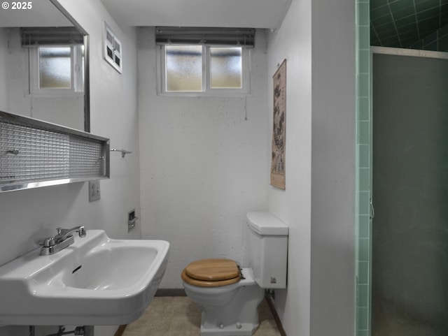 bathroom featuring sink, toilet, and walk in shower