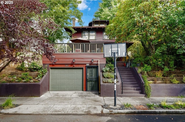 view of front of property featuring a garage, driveway, and stairs