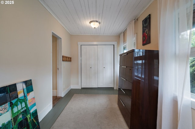 doorway to outside with wooden ceiling and baseboards