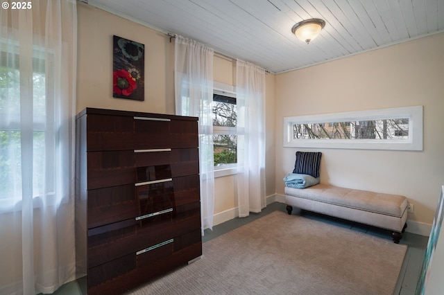 living area featuring wooden ceiling and baseboards