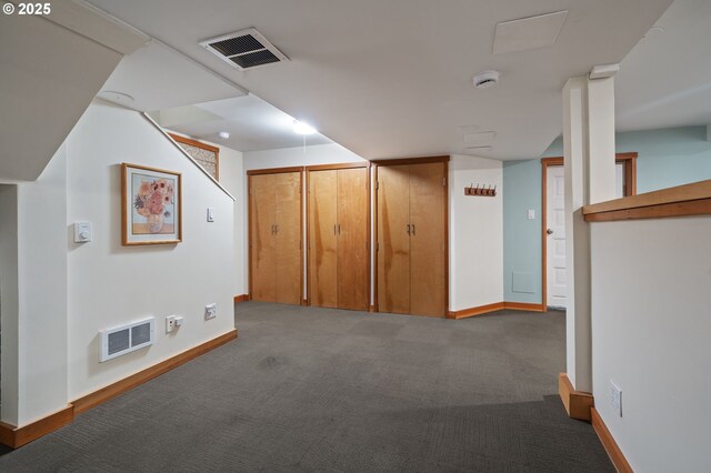 basement with carpet flooring, visible vents, and baseboards