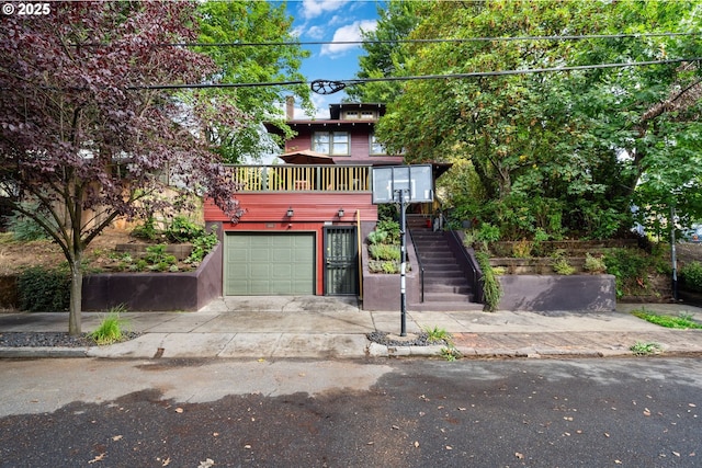 view of front facade featuring a garage and stairway