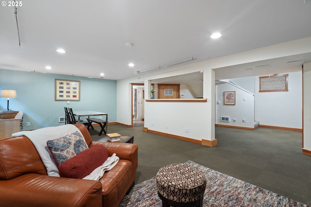 living area featuring recessed lighting and baseboards