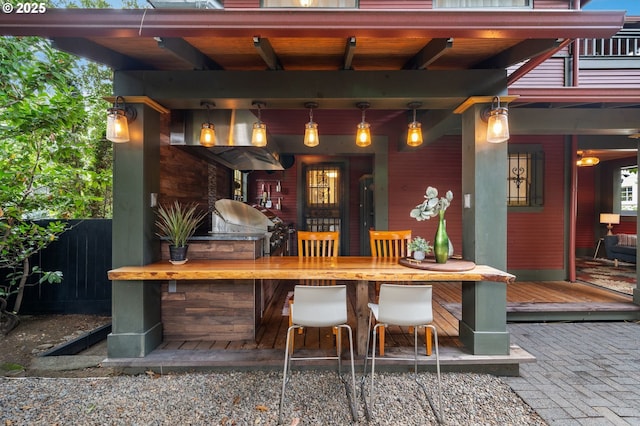 view of patio with outdoor dry bar, an outdoor kitchen, and fence