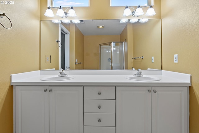 bathroom with a shower with door and vanity