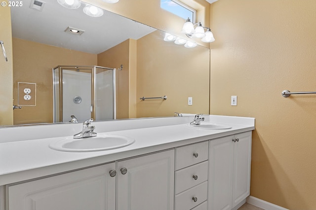 bathroom featuring vanity and a shower with shower door