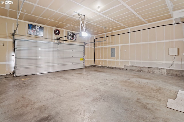 garage featuring a garage door opener and electric panel