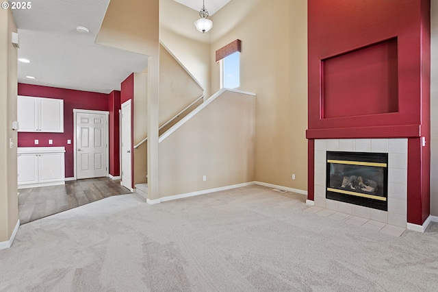 unfurnished living room featuring a fireplace and light carpet