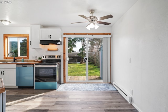 kitchen with dishwashing machine, stainless steel electric range, a sink, under cabinet range hood, and a baseboard heating unit