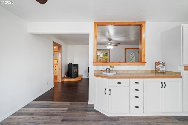 bathroom featuring baseboards, wood finished floors, ceiling fan, and vanity