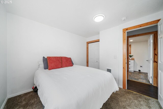 carpeted bedroom featuring baseboards, visible vents, and a closet