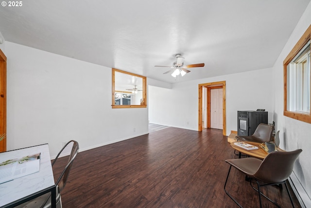 office area featuring dark wood finished floors, a ceiling fan, and baseboards