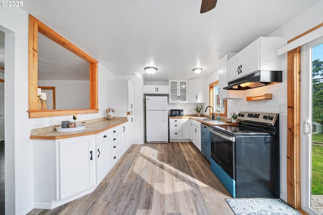 kitchen with black microwave, under cabinet range hood, dishwasher, freestanding refrigerator, and electric stove