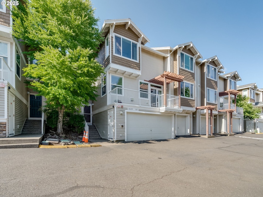 8620 SW 147th Ter Unit 101, Beaverton, OR 97007 - townhome / multi-family property featuring a garage, a residential view, and driveway