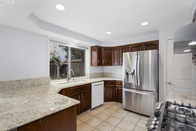 7134 SW 184th Pl, Beaverton, OR 97007 - kitchen with dishwasher, stainless steel fridge with ice dispenser, wall chimney range hood, light tile patterned floors, and recessed lighting