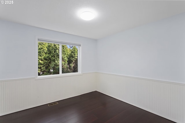 7134 SW 184th Pl, Beaverton, OR 97007 - unfurnished room with a wainscoted wall and dark wood-style flooring