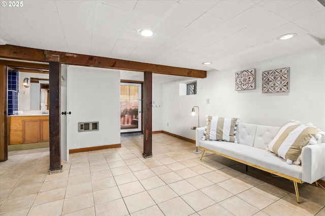 living room featuring recessed lighting, baseboards, and light tile patterned floors
