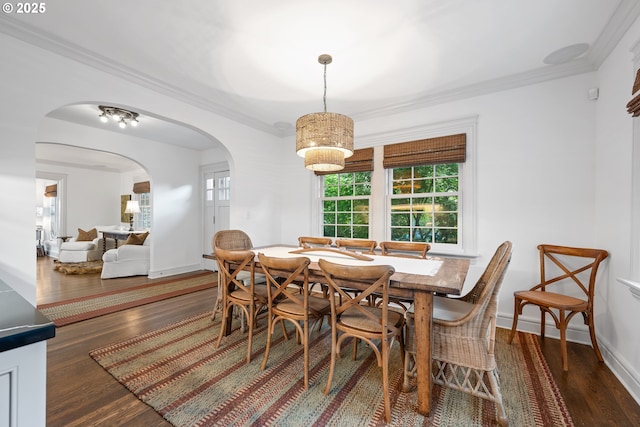 4108 NE 30th Ave Unit A & B, Portland, OR 97211 - dining space featuring ornamental molding, wood finished floors, arched walkways, and baseboards