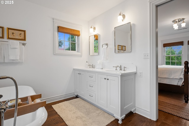 4108 NE 30th Ave Unit A & B, Portland, OR 97211 - ensuite bathroom featuring double vanity, baseboards, and wood finished floors