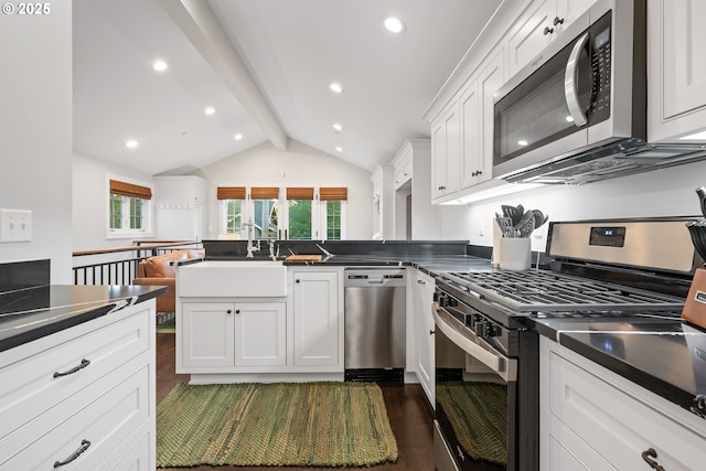 4108 NE 30th Ave Unit A & B, Portland, OR 97211 - kitchen featuring stainless steel appliances, a sink, dark countertops, white cabinets, and a peninsula