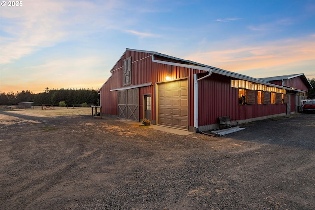 19905 SE Neck Rd, Dayton, OR 97114 - property exterior at dusk with an outbuilding, a detached garage, and driveway