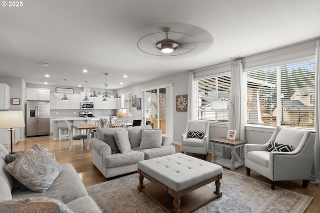 living area featuring recessed lighting and light wood-type flooring