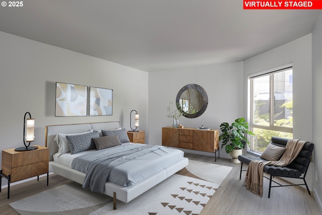 bedroom featuring light wood-style flooring