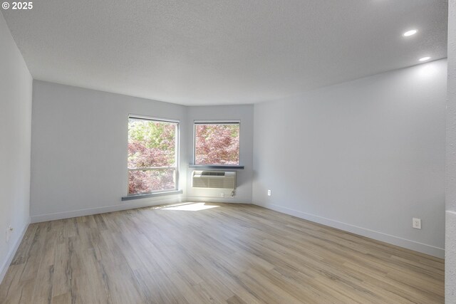 unfurnished room with baseboards, recessed lighting, a textured ceiling, and light wood finished floors