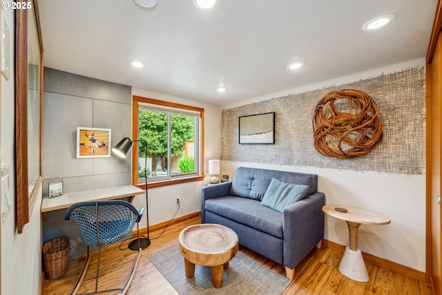 living area featuring baseboards, recessed lighting, and wood finished floors