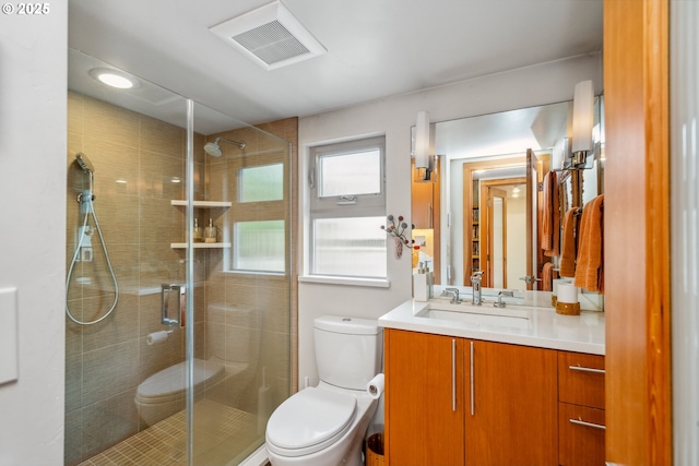 full bath with toilet, visible vents, and a shower stall