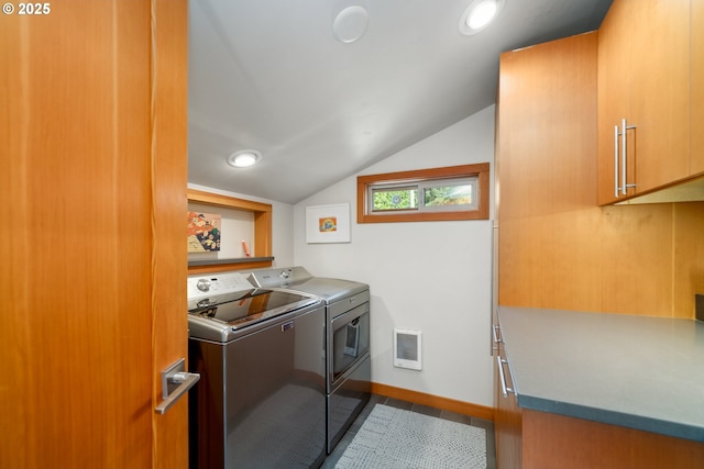 washroom featuring separate washer and dryer, baseboards, cabinet space, and visible vents
