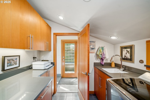 washroom with a sink, cabinet space, and dark tile patterned flooring