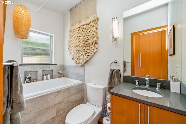 bathroom with toilet, a bath, and vanity