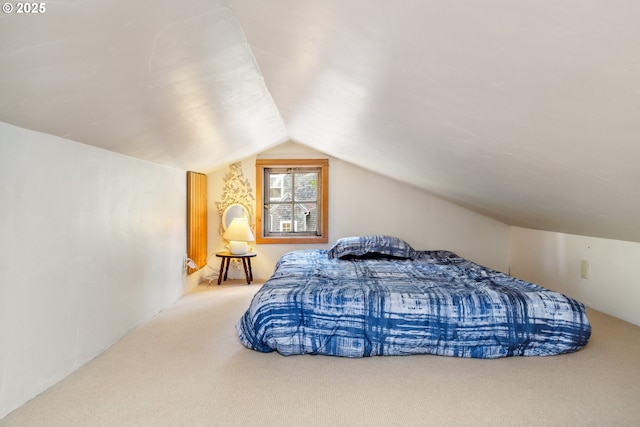 carpeted bedroom with vaulted ceiling
