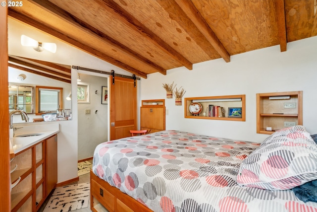 bedroom with vaulted ceiling with beams, a barn door, and a sink